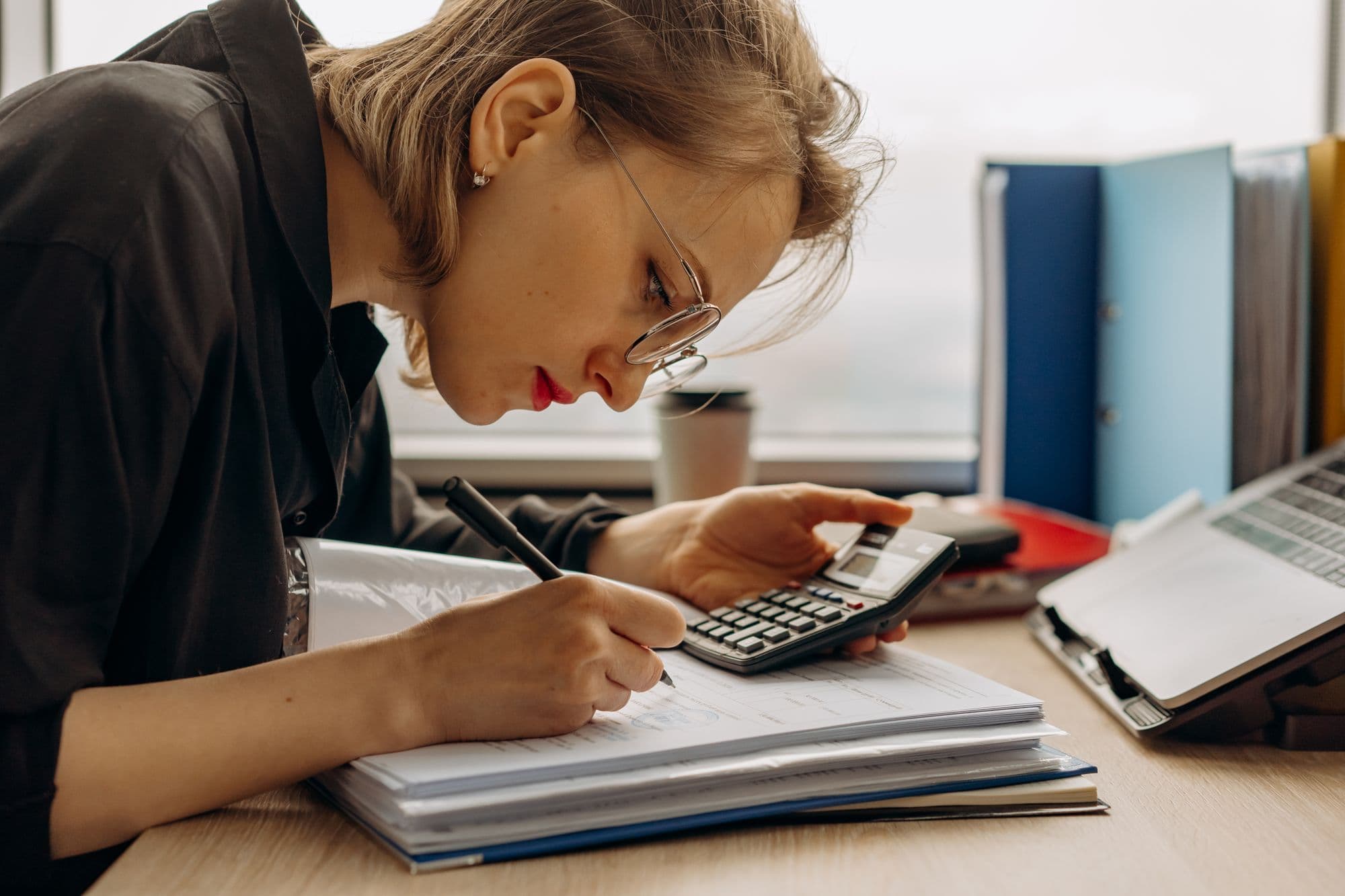 Bookkeeper working through a stack of client documents